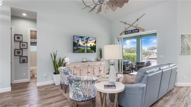 162 Windward Cay, Naples, FL 34114 - living area with light wood-style flooring, high vaulted ceiling, ceiling fan, and baseboards