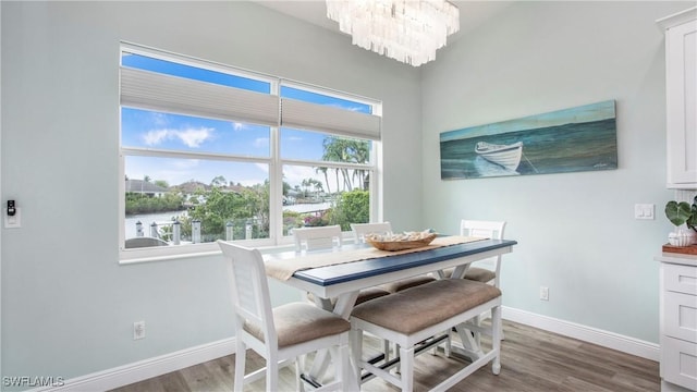 162 Windward Cay, Naples, FL 34114 - dining area featuring baseboards, an inviting chandelier, and wood finished floors