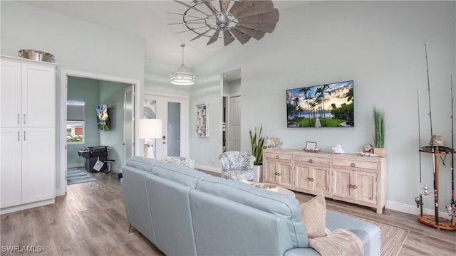 162 Windward Cay, Naples, FL 34114 - living room featuring baseboards, a ceiling fan, high vaulted ceiling, and light wood-style floors