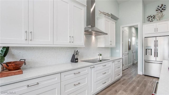 162 Windward Cay, Naples, FL 34114 - kitchen featuring light wood-type flooring, wall chimney range hood, white cabinetry, high quality fridge, and black electric stovetop