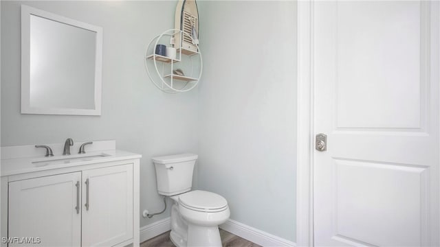 162 Windward Cay, Naples, FL 34114 - bathroom featuring toilet, wood finished floors, vanity, and baseboards