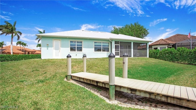 162 Windward Cay, Naples, FL 34114 - rear view of property featuring a sunroom, a lawn, and stucco siding