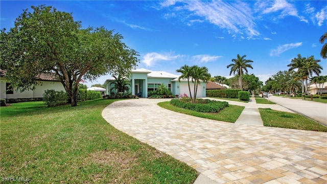 162 Windward Cay, Naples, FL 34114 - view of front of house featuring an attached garage, stucco siding, a front lawn, and curved driveway