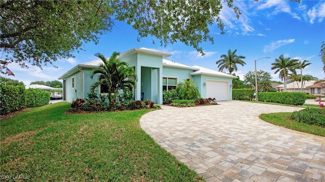 162 Windward Cay, Naples, FL 34114 - view of front of house featuring a front yard, decorative driveway, a garage, and stucco siding