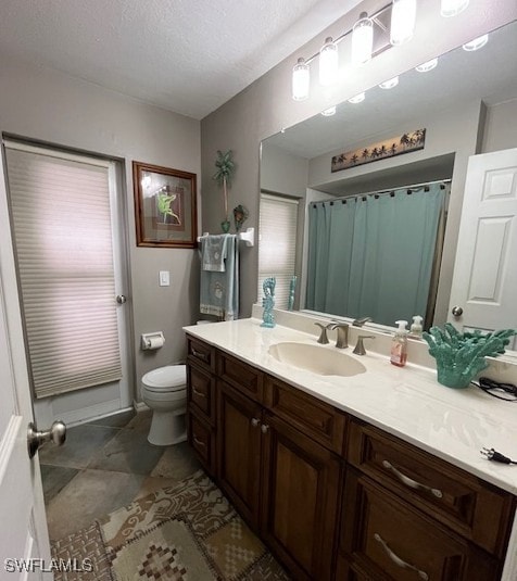 408 SE 19th Ln, Cape Coral, FL 33990 - bathroom with toilet, vanity, and a textured ceiling