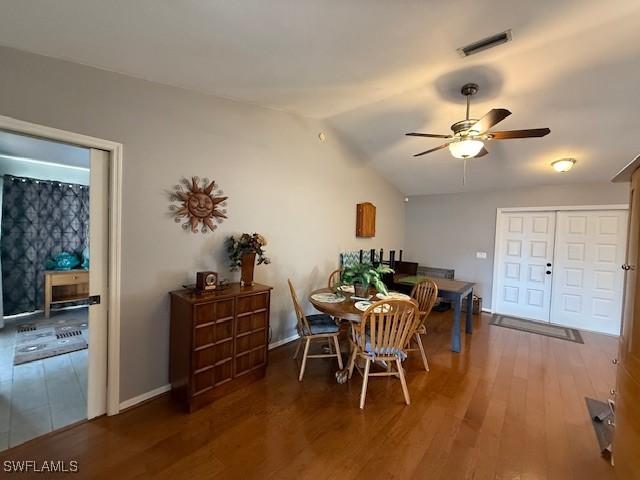 408 SE 19th Ln, Cape Coral, FL 33990 - dining area with vaulted ceiling, baseboards, ceiling fan, visible vents, and wood finished floors