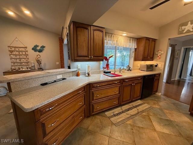 408 SE 19th Ln, Cape Coral, FL 33990 - kitchen featuring vaulted ceiling, light countertops, a sink, dishwasher, and a peninsula