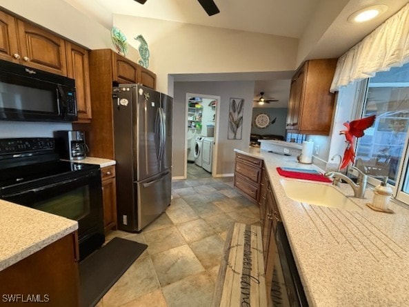 408 SE 19th Ln, Cape Coral, FL 33990 - kitchen with light countertops, a ceiling fan, a sink, washing machine and dryer, and black appliances
