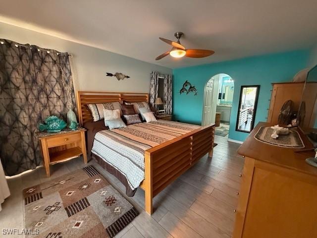 408 SE 19th Ln, Cape Coral, FL 33990 - bedroom featuring arched walkways, wood finished floors, and a ceiling fan