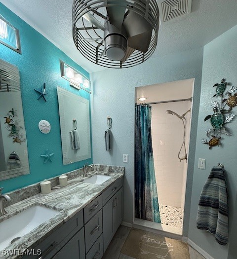 408 SE 19th Ln, Cape Coral, FL 33990 - full bath featuring double vanity, a sink, a tile shower, and ceiling fan