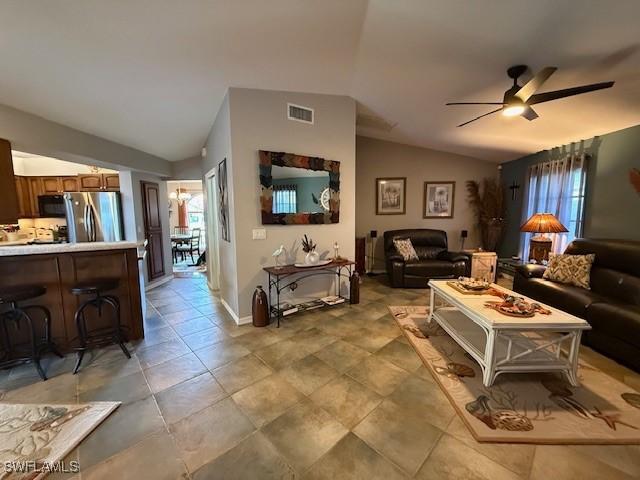 408 SE 19th Ln, Cape Coral, FL 33990 - living area with a ceiling fan, baseboards, vaulted ceiling, and visible vents