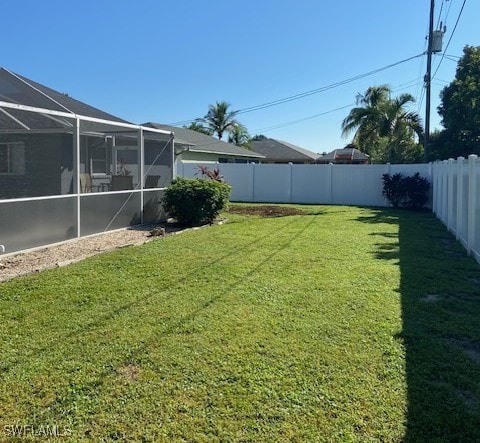 408 SE 19th Ln, Cape Coral, FL 33990 - view of yard with a fenced backyard and a lanai