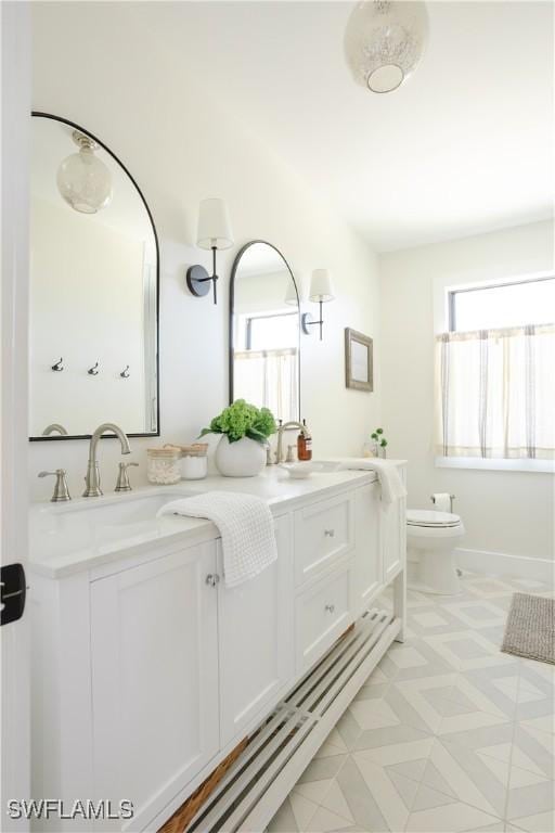 167 1st St, Bonita Springs, FL 34134 - bathroom with double vanity, toilet, and a sink
