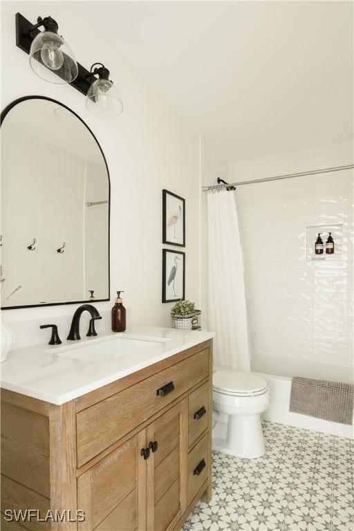 167 1st St, Bonita Springs, FL 34134 - full bathroom with tile patterned floors, toilet, shower / tub combo with curtain, and vanity