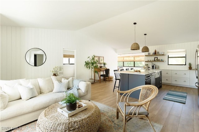 167 1st St, Bonita Springs, FL 34134 - living room with light wood finished floors and lofted ceiling