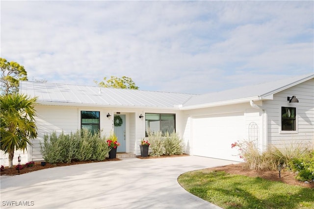 167 1st St, Bonita Springs, FL 34134 - view of front of house with driveway and an attached garage