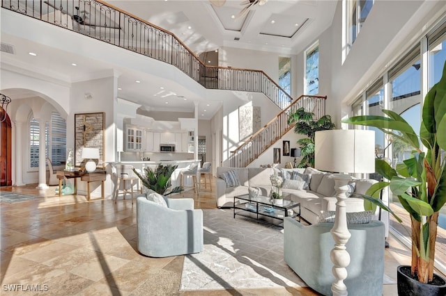 159 Geranium Ct, Marco Island, FL 34145 - living area with a high ceiling, ornamental molding, plenty of natural light, stairs, and recessed lighting