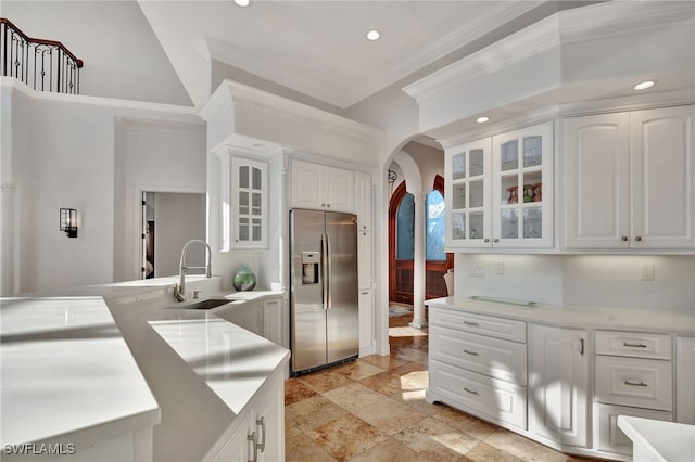 159 Geranium Ct, Marco Island, FL 34145 - kitchen featuring stainless steel fridge with ice dispenser, crown molding, arched walkways, recessed lighting, and glass insert cabinets