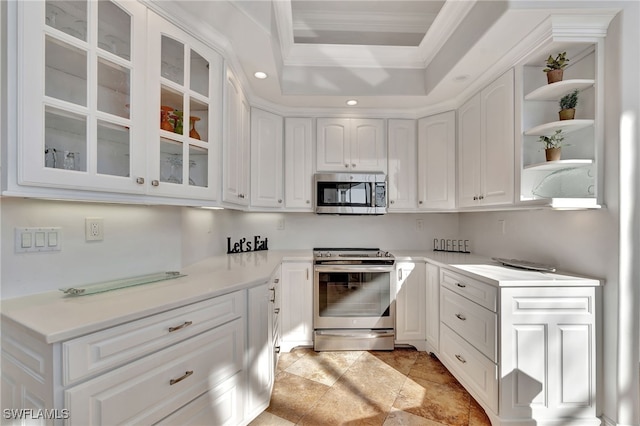 159 Geranium Ct, Marco Island, FL 34145 - kitchen with appliances with stainless steel finishes, a raised ceiling, white cabinetry, ornamental molding, and open shelves