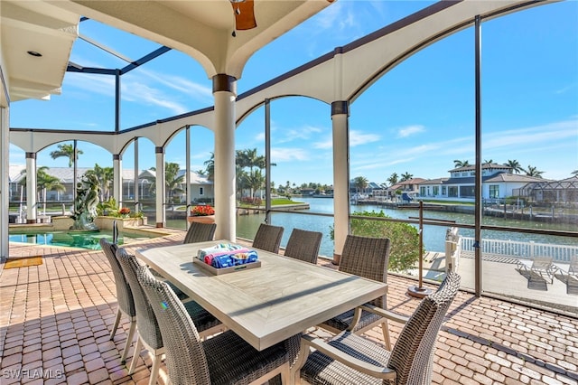 159 Geranium Ct, Marco Island, FL 34145 - view of patio / terrace with a water view, a residential view, a ceiling fan, outdoor dining space, and an outdoor pool