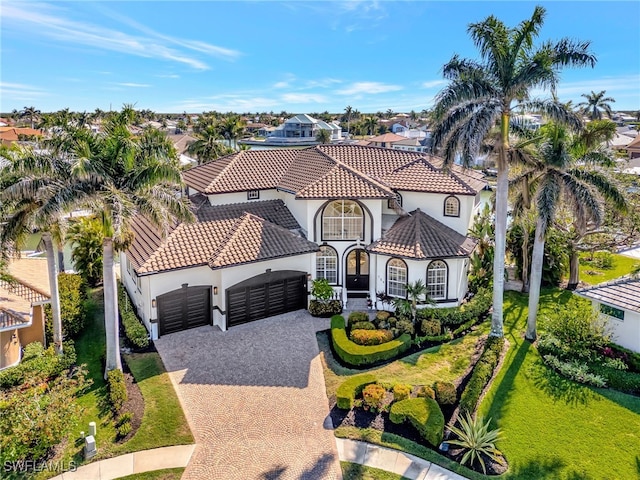 159 Geranium Ct, Marco Island, FL 34145 - mediterranean / spanish home featuring a garage, stucco siding, decorative driveway, and a residential view
