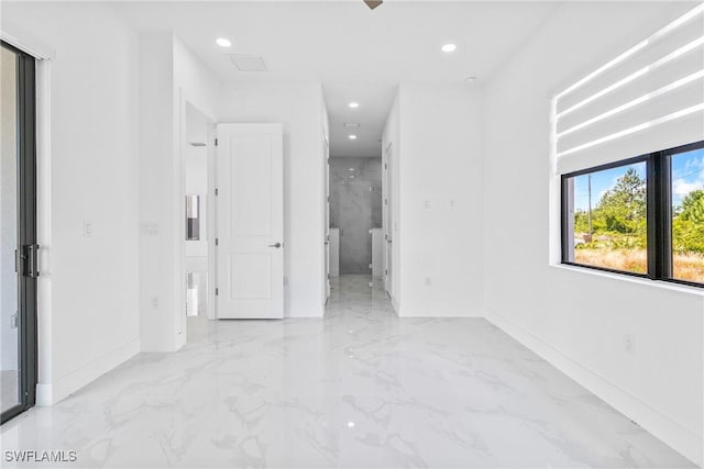 unfurnished bedroom with baseboards, recessed lighting, marble finish floor, and ensuite bath