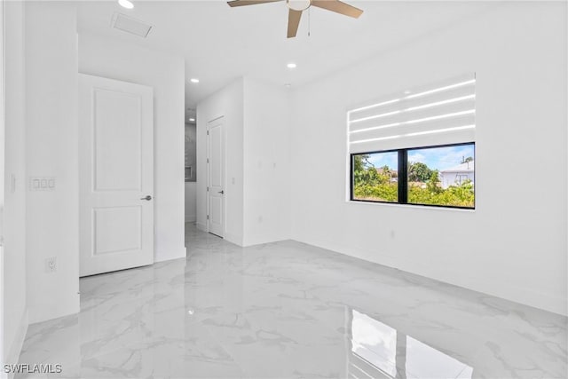 spare room with baseboards, a ceiling fan, recessed lighting, and marble finish floor