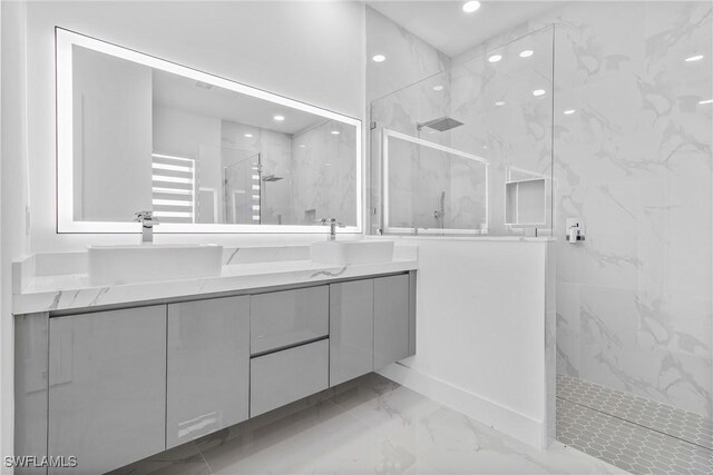 full bath with double vanity, marble finish floor, recessed lighting, a sink, and a marble finish shower