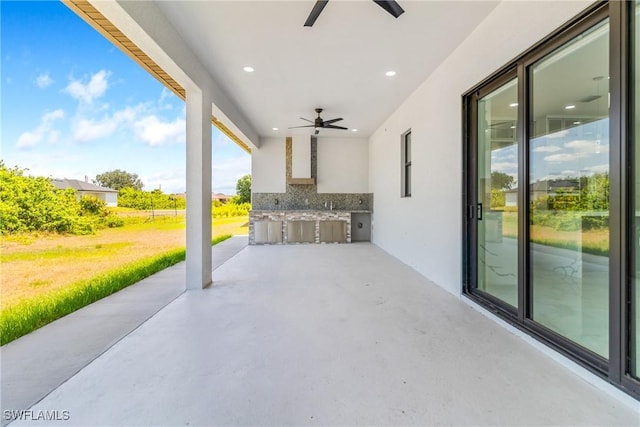 view of patio with exterior kitchen and ceiling fan