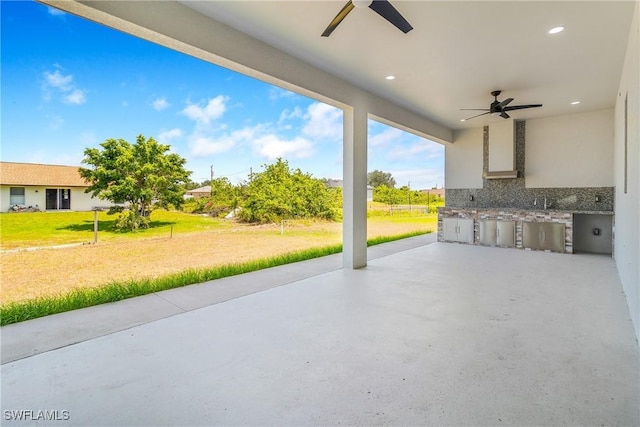 view of patio / terrace with exterior kitchen and ceiling fan