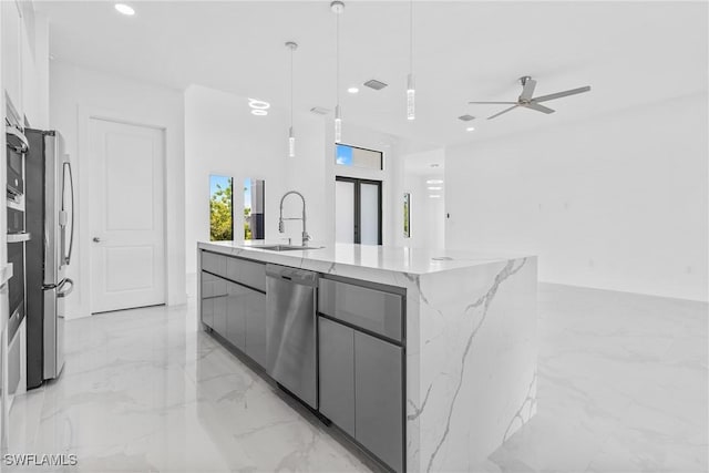 kitchen with a sink, marble finish floor, modern cabinets, a ceiling fan, and stainless steel appliances