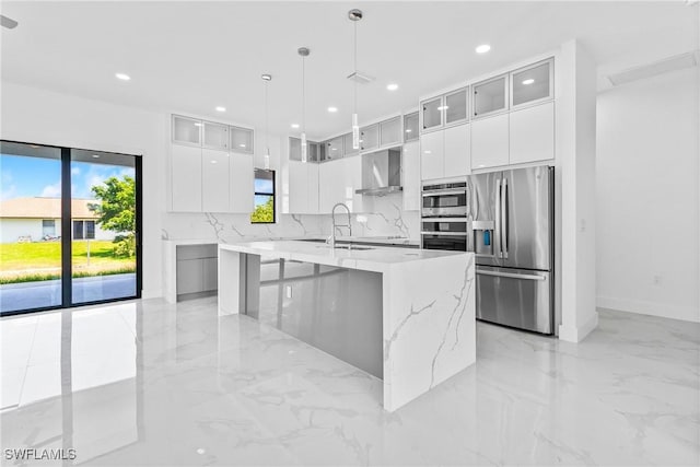kitchen featuring modern cabinets, stainless steel appliances, wall chimney exhaust hood, and a wealth of natural light