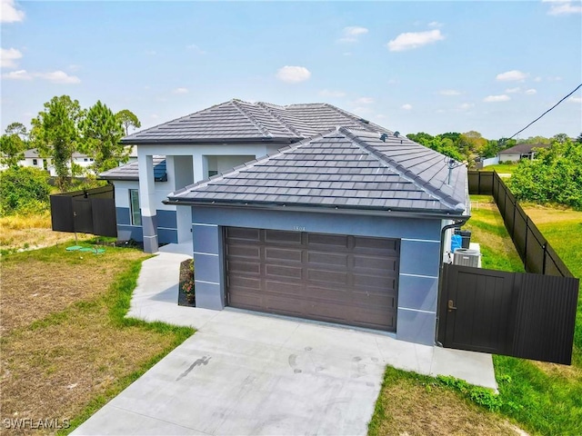 view of front of home with a garage, fence, a front yard, stucco siding, and concrete driveway