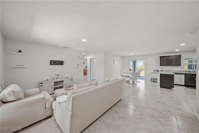living room with recessed lighting and light tile patterned floors