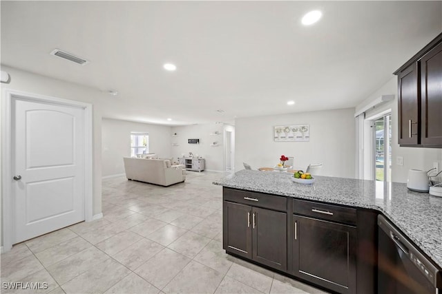 kitchen featuring dishwashing machine, visible vents, light stone counters, and a peninsula