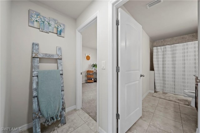 full bathroom with baseboards, visible vents, tile patterned floors, and toilet