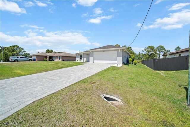 single story home with stucco siding, an attached garage, a front yard, and decorative driveway