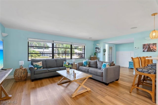 living room with light wood finished floors and baseboards