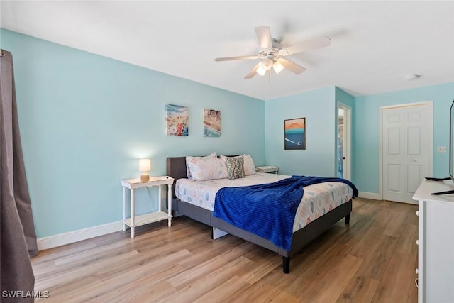 bedroom featuring baseboards, a ceiling fan, and light wood-style floors