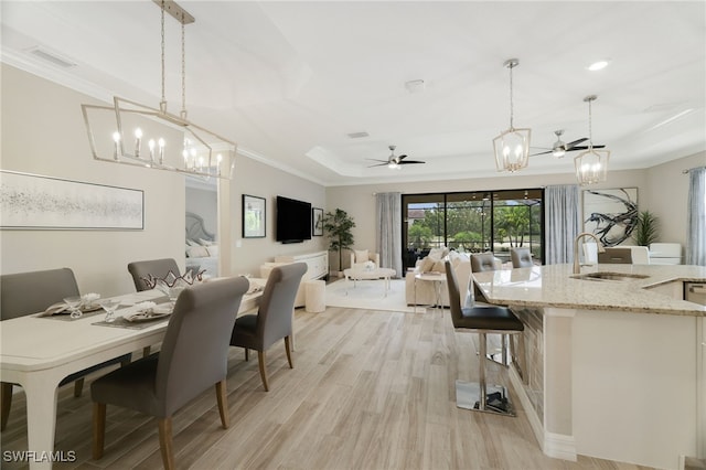 28091 Foxrock Ct, Bonita Springs, FL 34135 - dining room with light wood-style floors, visible vents, ceiling fan with notable chandelier, and ornamental molding