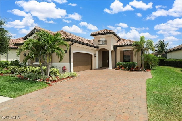 28091 Foxrock Ct, Bonita Springs, FL 34135 - mediterranean / spanish-style home with stucco siding, a tiled roof, decorative driveway, and an attached garage