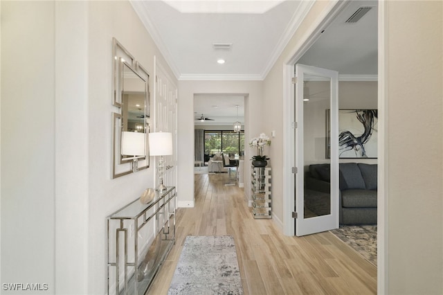 28091 Foxrock Ct, Bonita Springs, FL 34135 - corridor with baseboards, visible vents, light wood-type flooring, and crown molding