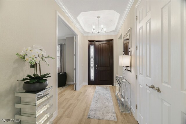 28091 Foxrock Ct, Bonita Springs, FL 34135 - entryway featuring ornamental molding, baseboards, a chandelier, and light wood-style floors