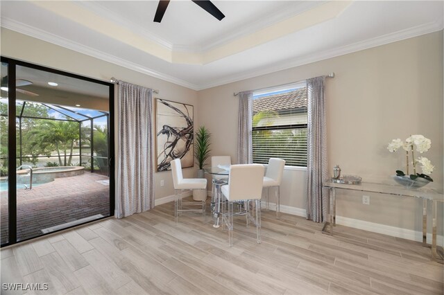 28091 Foxrock Ct, Bonita Springs, FL 34135 - dining area with baseboards, a raised ceiling, ornamental molding, ceiling fan, and wood finished floors