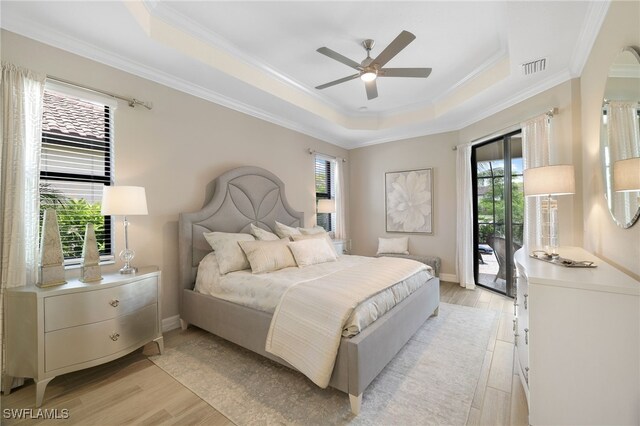 28091 Foxrock Ct, Bonita Springs, FL 34135 - bedroom with access to exterior, light wood-type flooring, multiple windows, and a tray ceiling