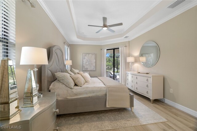 28091 Foxrock Ct, Bonita Springs, FL 34135 - bedroom with visible vents, baseboards, crown molding, a tray ceiling, and light wood-style flooring