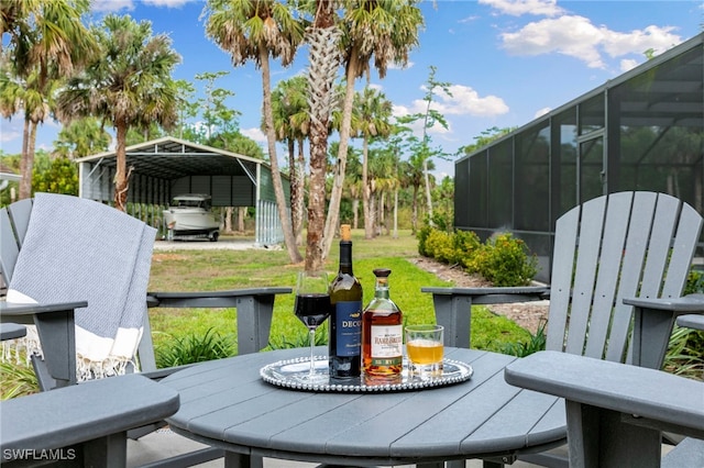 1020 19th St SW, Naples, FL 34117 - deck featuring a carport, outdoor dining space, and a yard
