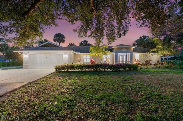 1020 19th St SW, Naples, FL 34117 - ranch-style house featuring an attached garage, a front yard, driveway, and stucco siding