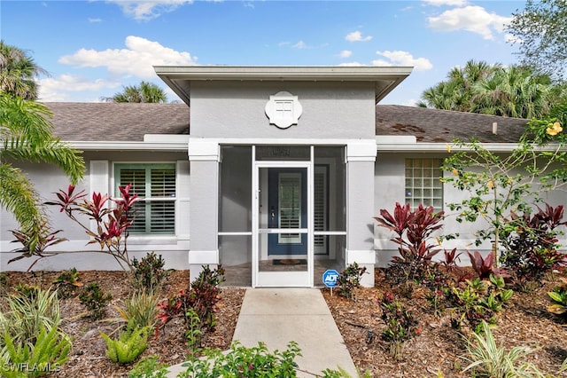 1020 19th St SW, Naples, FL 34117 - doorway to property featuring roof with shingles and stucco siding