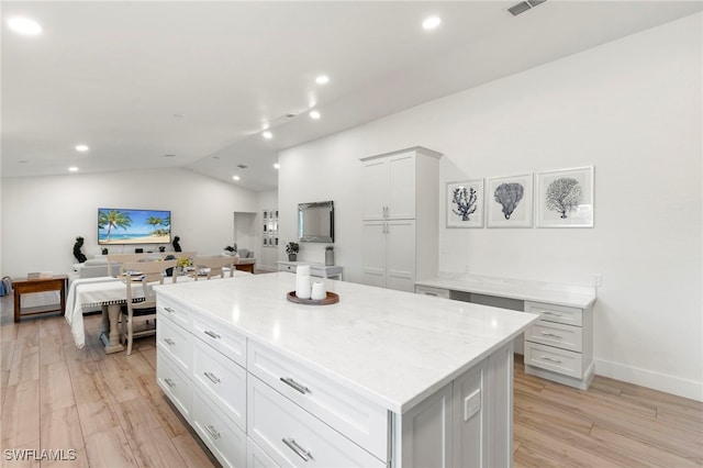 1020 19th St SW, Naples, FL 34117 - kitchen with lofted ceiling, recessed lighting, a kitchen island, light wood-style flooring, and white cabinets